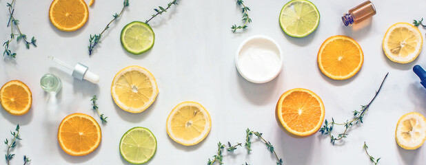 Natural citrus cosmetics with vitamin C, cosmetic bottles, citrus circles, lime, orange, lemon, top...