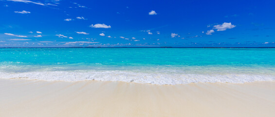 Closeup of sand on beach and blue summer sky. Panoramic beach landscape. Empty tropical beach and...
