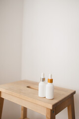 Fototapeta na wymiar two white bottle with dropper cap. The concept of beauty. Cosmetics for home care.