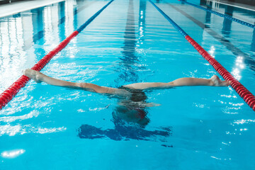 synchronized swimming athlete trains alone in the swimming pool. Training in the water upside down....