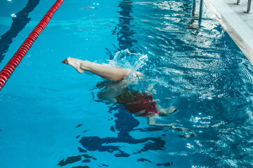 synchronized swimming athlete trains alone in the swimming pool. Training in the water upside down....