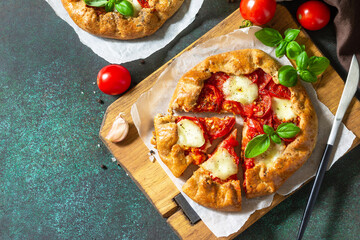 Healthy pastries gluten free, made from rye flour, diet food. Galette tomatoes, mozzarella and...