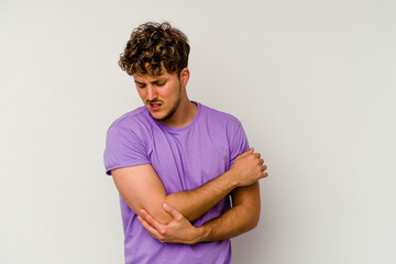 Young caucasian man isolated on white background massaging elbow, suffering after a bad movement.