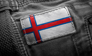 Tag on dark clothing in the form of the flag of the Faroe Islands