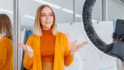 Online teacher records video lessons. Manager do presentation during online meeting. Woman behind graphic on whiteboard. Remote work. Coach mentor do live webinar. Long web banner.