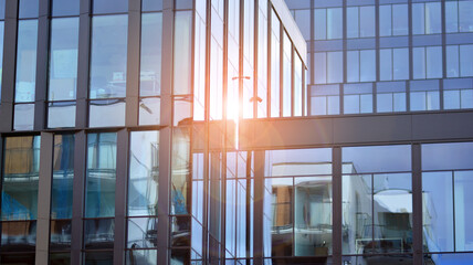 Modern office building detail, glass surface on a clear sky background. Transparent glass wall of office building.  