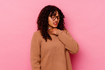 Young mixed race woman isolated on pink background suffers pain in throat due a virus or infection.