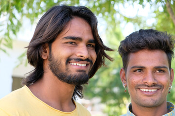 Portrait of two happy Indian males in the park