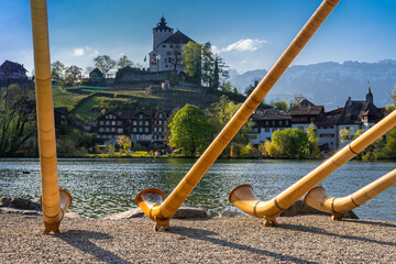 The alpine horns ensemble at the swiss lake and village of Werdenberg