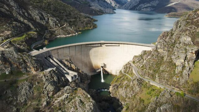 Aerial drone footage. Water dam and reservoir lake, generating hydro electricity power renewable energy and sustainable development. High quality 4k footage.