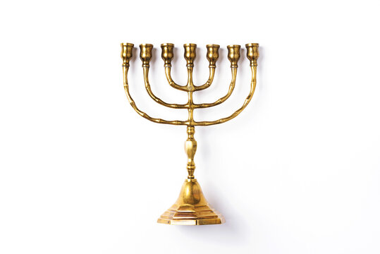 Golden hanukkah menorah on isolated on white background. Jewish holiday banner with copy space. Ancient ritual religious candle menorah