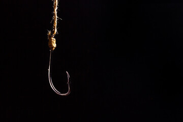 Empty fishing hook on a dark background. Metal fishing hook.