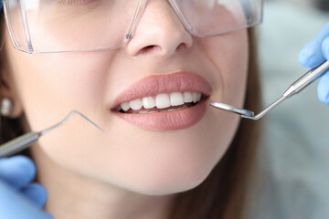 Portrait of woman with white beautiful teeth at dentist appointment