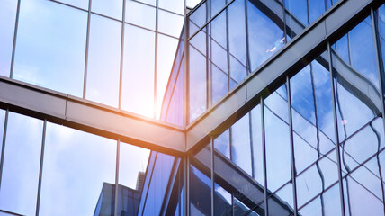 Modern office building detail, glass surface on a clear sky background. Transparent glass wall of office building.  