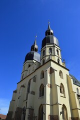 Obraz premium Two massive towers of gothic cathedral of Saint Nicholas in Trnava, western Slovakia, central Europe. Spring daylight sunshine, clear blue skies.