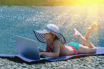Learning always and everywhere. Humorous portrait of little cute girl learning remotely with laptop...