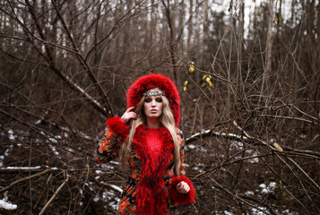 slavic girl in traditional clothes posing in the forest. Slavic beauty.