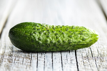 Fresh green cucumber on wooden table.