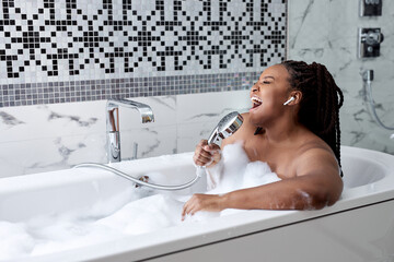 Portrait beautiful young afro american woman relax and leisure in bathtub decoration in bathroom...