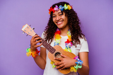 Young hawaiian woman playing ukelele isolated on purple background
