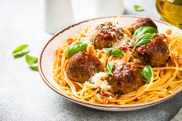 Pasta with Meatballs in tomato sauce at light table.