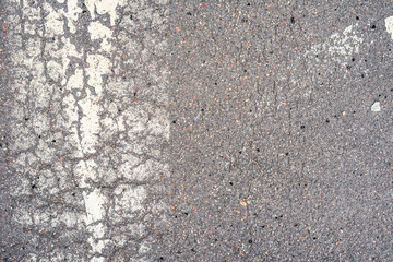 Old asphalt on the road. Marking on a pedestrian crossing. City environment. Top view close up.