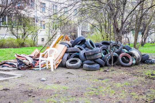 Pile of old multicolored car tires dug in playgrounds. Multicolor used tires. various sizes colored tires. Garbage on the street.