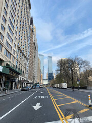 Wide Manhattan Street with Tall Buildings and Direction Arrow