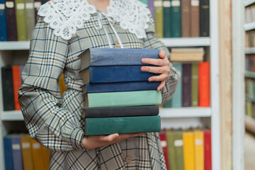 woman holding books - education concept
