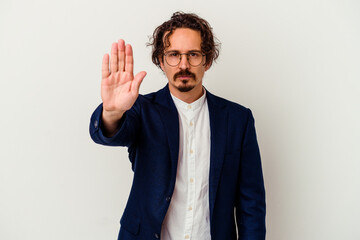 Young business man isolated on white background standing with outstretched hand showing stop sign, preventing you.