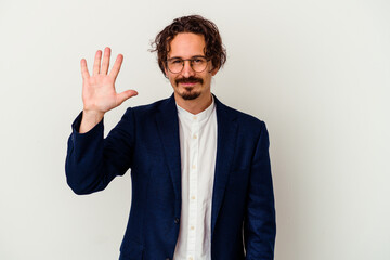 Young business man isolated on white background smiling cheerful showing number five with fingers.