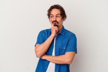 Young caucasian man isolated on white background contemplating, planning a strategy, thinking about the way of a business.