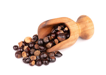 Guarana seed in wooden scoop, isolated on white background. Dietary supplement guarana, caffeine cource for energy drinks.