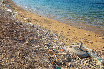 Fototapeta na wymiar Beach polluted with plastic garbage due to sea currents, Vis island, Croatia.