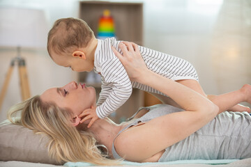 mother lifting baby into the air