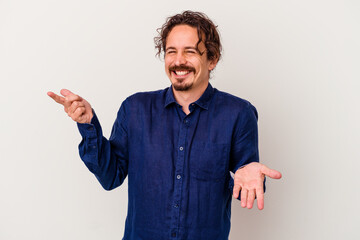 Young caucasian man isolated on white background joyful laughing a lot. Happiness concept.