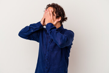 Young caucasian man isolated on white background afraid covering eyes with hands.