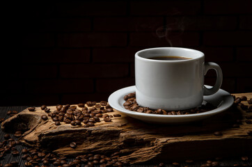 Cup of coffee on a rustic wood. Coffee grains.