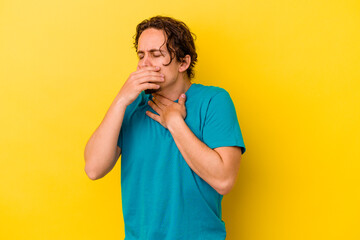 Young caucasian man isolated on yellow background suffers pain in throat due a virus or infection.