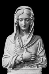 Black and white photo in close-up of marble sculpture representing a woman wearing a veil while standing with her arms crossed on her chest