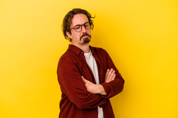 Young caucasian man isolated on yellow background tired of a repetitive task.