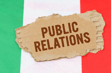 Against the background of the flag of Italy lies cardboard with the inscription - Public Relations