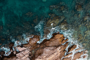 Aerial: waves crashing in the beach
