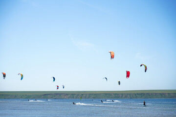 Kiteboarding competition, many kites in the sky. Southern Ukraine