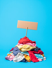 Clothes pile on a blue background. Textile recycling concept.