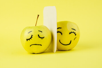 opposite different emotions from joy to sadness, happy to anger  Face on an apple - abstract image...