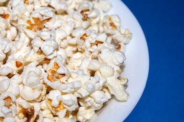 bowl of popcorn on blue background