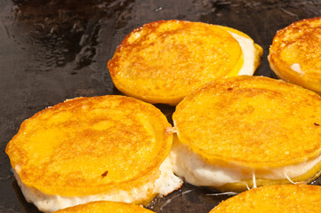 top, front view, close distance of Spanish grilled, cheese sandwich, on black grill