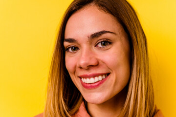 Young caucasian woman wearing invisible orthodontics isolated on yellow background