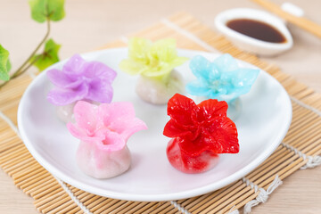 Fototapeta na wymiar Chinese style colorful flower dumplings or dim sum